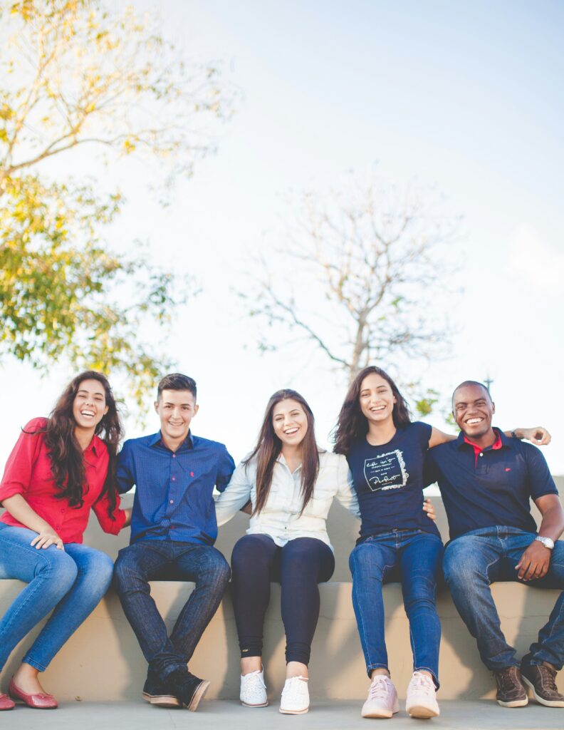 A group of young friends sitting together outdoors