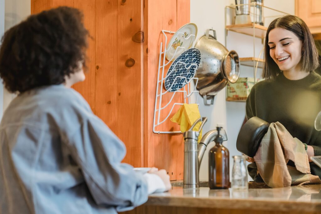 Two women talking together over a cup of tea at home