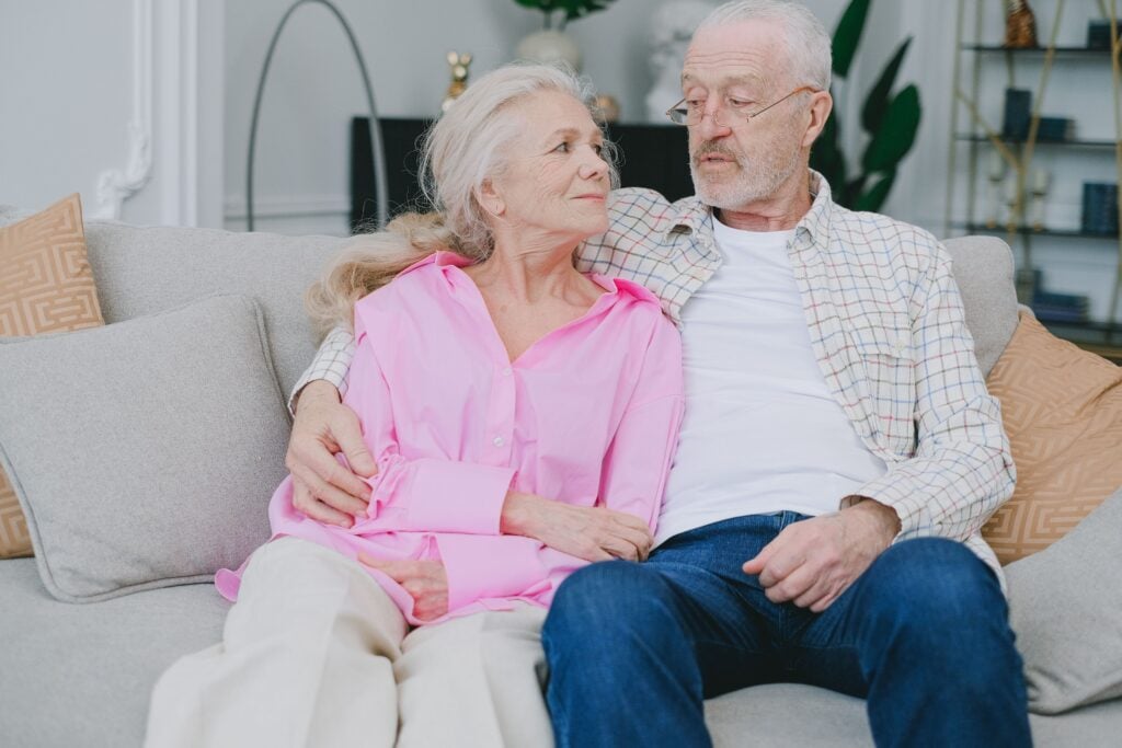 An older couple sitting together comfortably at home in Mornington