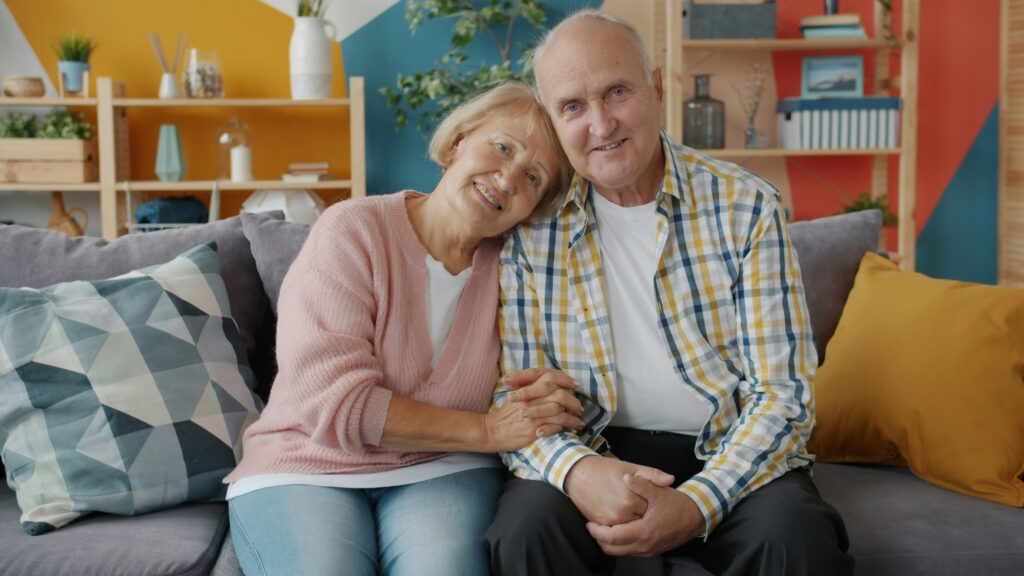 An older couple relaxing together on their couch